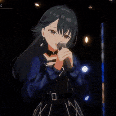 a girl with long black hair is singing into a microphone on a stage