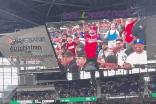 a crowd of people watching a baseball game in front of a sign that says loan depot park