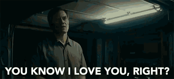 a man is standing in a dark room with a light on and says `` you know i love you , right ? ''