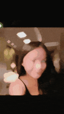 a blurry photo of a woman 's face with a light shining on it