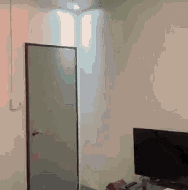 a room with a door and a tv on a table
