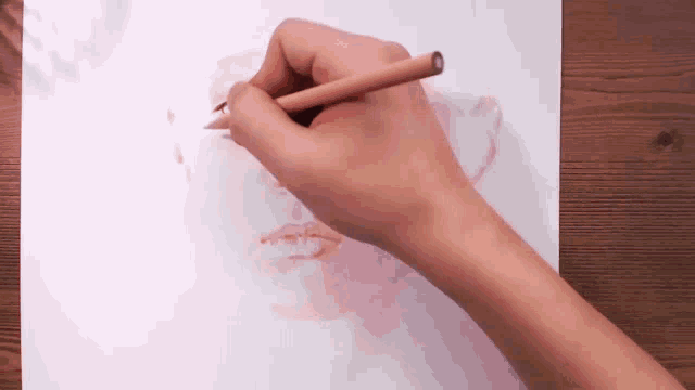 a person is drawing a portrait of a woman with a pencil .