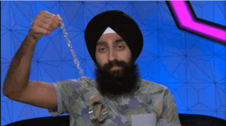 a man with a beard wearing a turban holds a chain in his hand