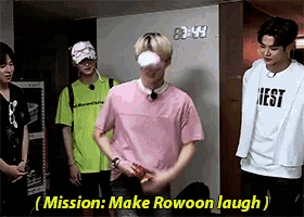a group of young men are standing next to each other in a room and one of them is wearing a pink shirt that says nest