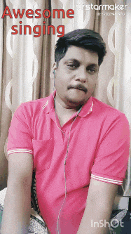 a man wearing headphones and a pink shirt is singing a song