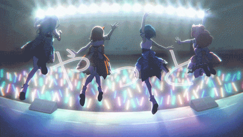 a group of girls are jumping in the air in front of a stage with lights