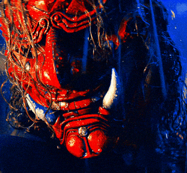 a close up of a person 's face with a red mask on