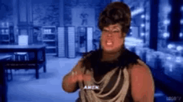a woman in a black and gold dress says amen in a blue room