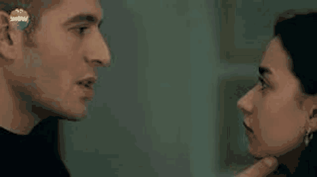 a man and a woman are looking into each other 's eyes .