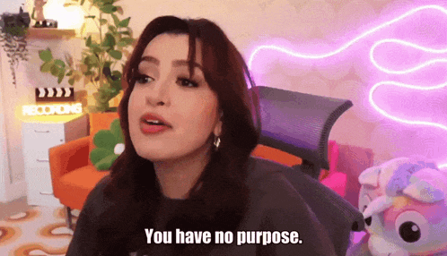 a woman says you have no purpose in front of a neon sign that says recording