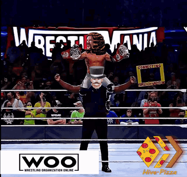 a man in a top hat is carrying another man in a wrestling ring sponsored by woo