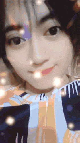 a close up of a girl 's face with a striped shirt