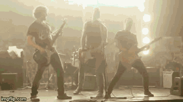 a group of men are playing guitars on a stage with imgflip.com written on the bottom