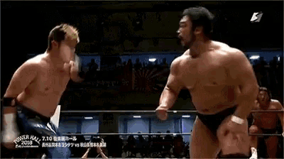 two men are wrestling in a ring with the year 2010 on the bottom left