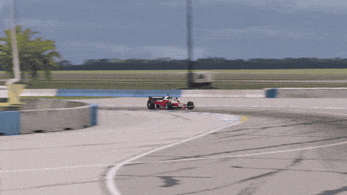 a red and white race car has the number 1 on the side