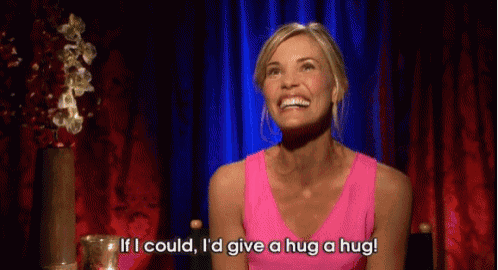 a woman in a pink tank top is saying if i could i 'd give a hug a hug