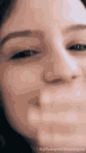a close up of a woman 's face with the words gifsdayrol / @luvdayrol at the bottom
