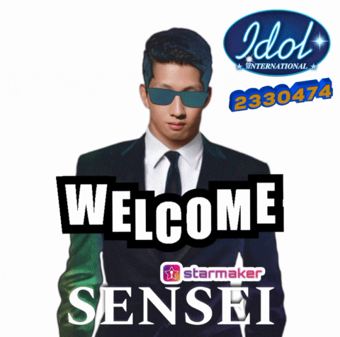 a man in a suit and tie is standing in front of a sign that reads welcome sensei