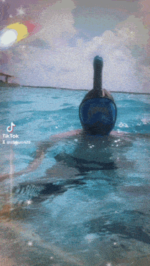 a person wearing a full face mask is swimming in a pool with a tiktok watermark