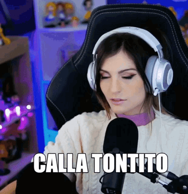 a woman wearing headphones is sitting in front of a microphone and says calla tonito