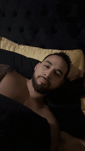 a blurry picture of a person laying on a bed with their eyes closed