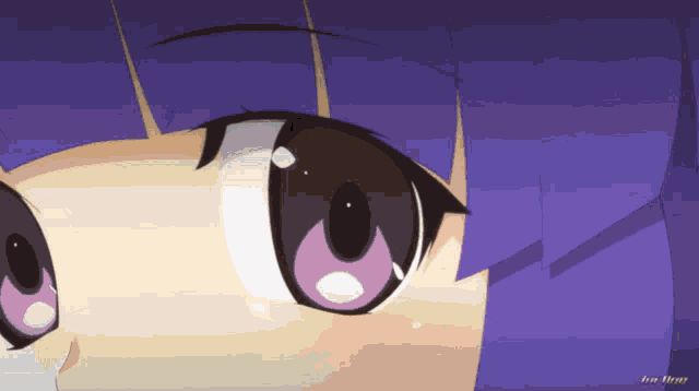 a close up of a girl 's face with purple hair and a blurred background