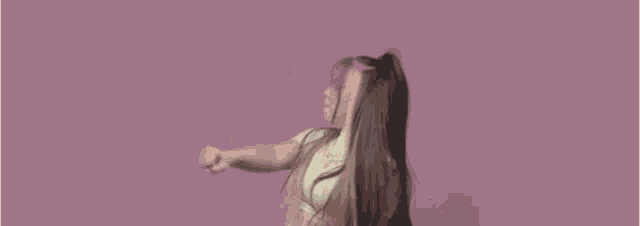 a woman with long hair is wearing a necklace and a white shirt .