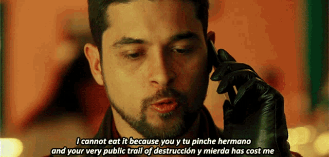 a man talking on a cell phone with a caption that says i cannot eat it