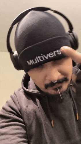 a man wearing a beanie that says multivers on it