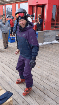 a man wearing a helmet and a jacket that says arcteryx on it