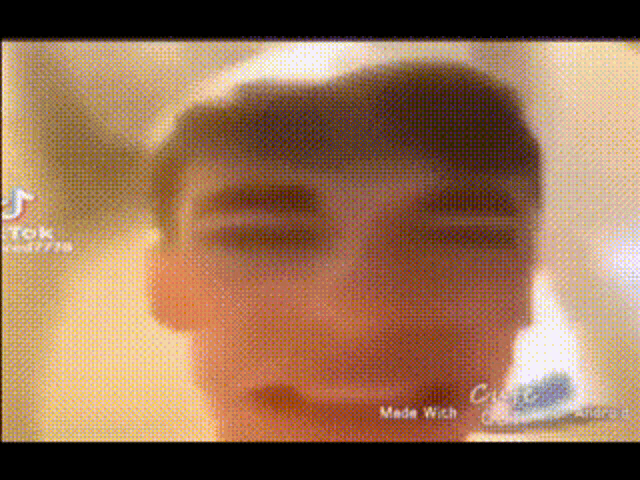 a close up of a man 's face with a blurry background