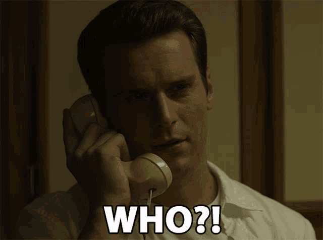 a man talking on a phone with the words who written on the bottom