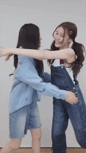 two girls are hugging each other and one has a star on her hair