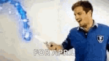 a man in a blue shirt is holding a lightning bolt in his hand and says `` for april '' .