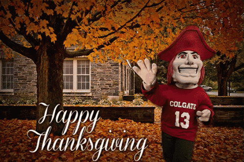a colgate mascot says happy thanksgiving in front of a stone building