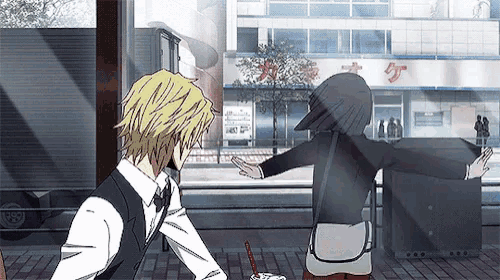 a man and a woman are standing next to each other in front of a building with chinese characters on it