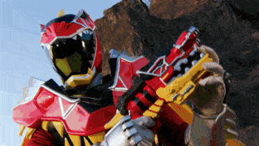 a person in a red and yellow costume holding a red and yellow gun