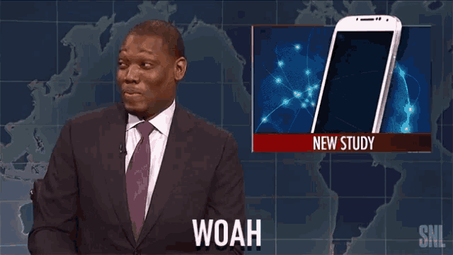 a man in a suit and tie says woah in front of a phone screen