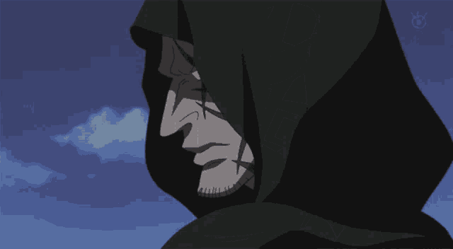 a man with a hood on his head looks down