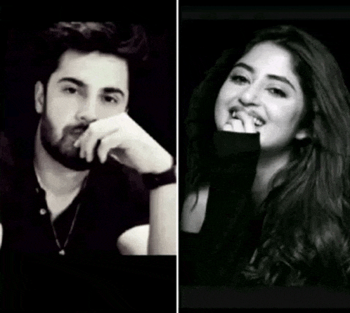 a man with a beard and a woman with long hair are standing next to each other in a black and white photo .