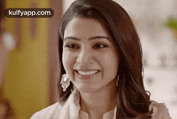 a close up of a woman 's face smiling .