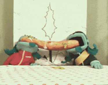 a couple of stuffed animals are eating a pizza together