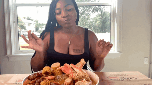 a woman with a tattoo on her chest is eating a bowl of food
