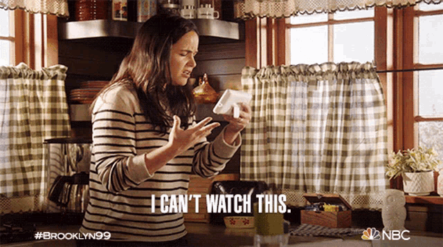 a woman in a striped shirt says " i can 't watch this " in a kitchen