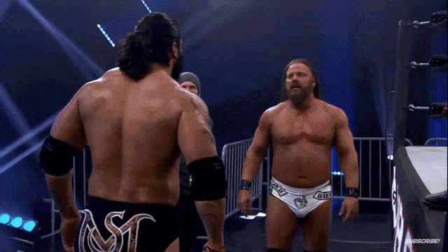 a wrestler in a ring with the word bti on the back