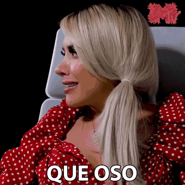 a woman in a red polka dot dress says " que oso "