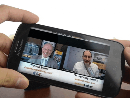 a person is holding a lenovo phone with richard blank and dr. jeremy weiss on the screen