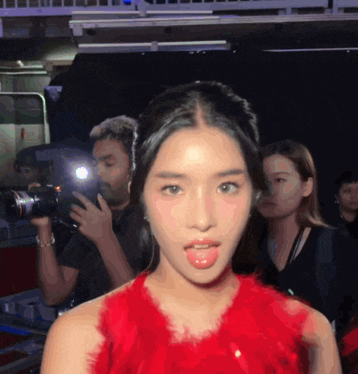 a woman in a red dress sticking out her tongue