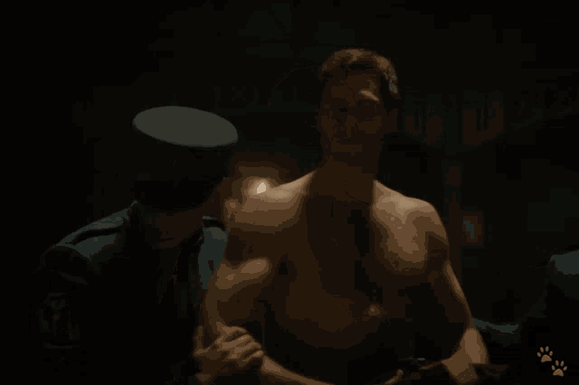 a man without a shirt is surrounded by police officers