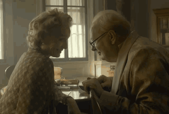 a man and a woman are looking at each other and smiling